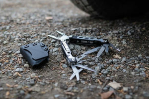Multitool on the ground next to a vehicle tire